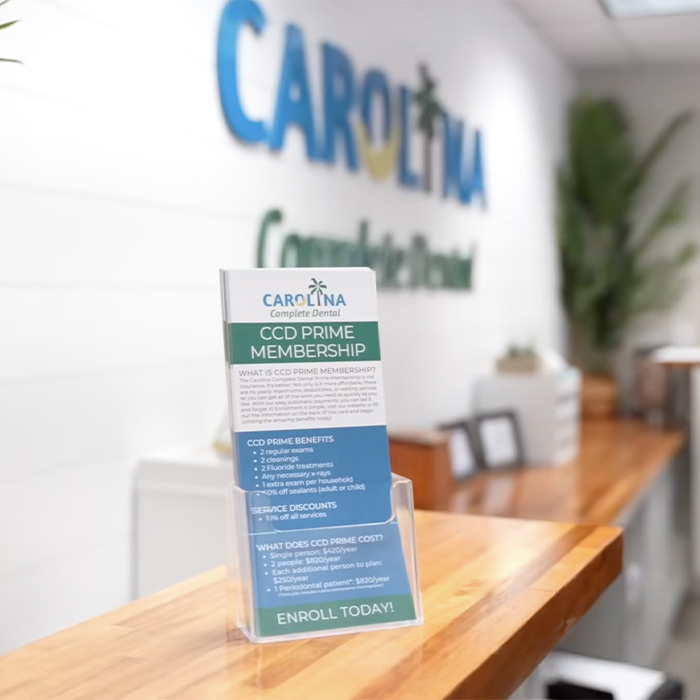 Person typing on a calculator while writing on a receipt