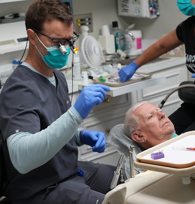 Dentist performing a treatment on a patient with dental implants in Goose Creek