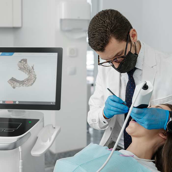 Dentist capturing digital impressions of a patients teeth