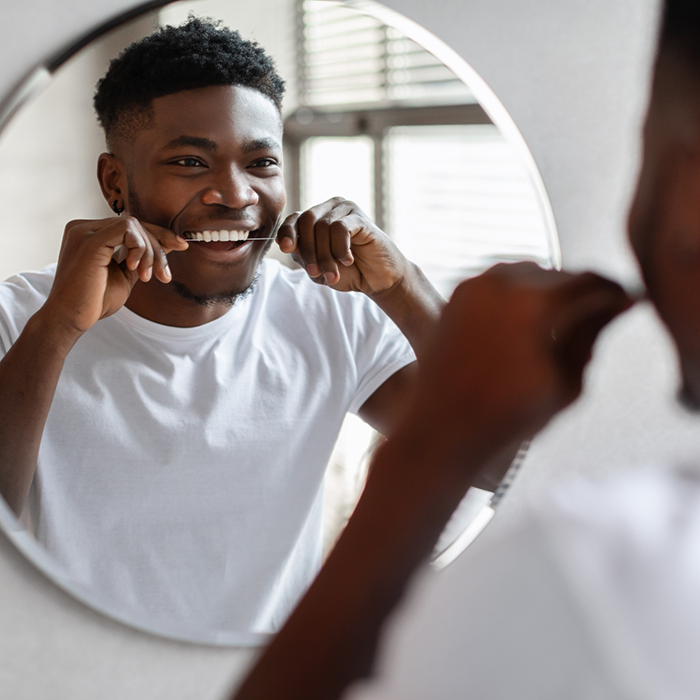Man flossing his teeth