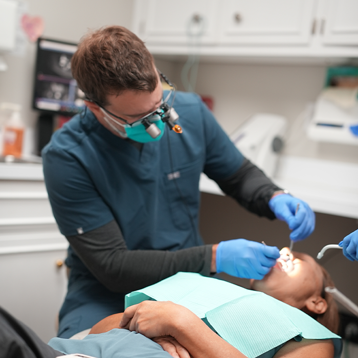 Dentist performing gum disease treatment on a Goose Creek dental patient