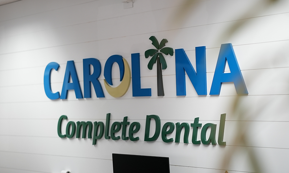 Carolina Complete Dental sign on a white wall