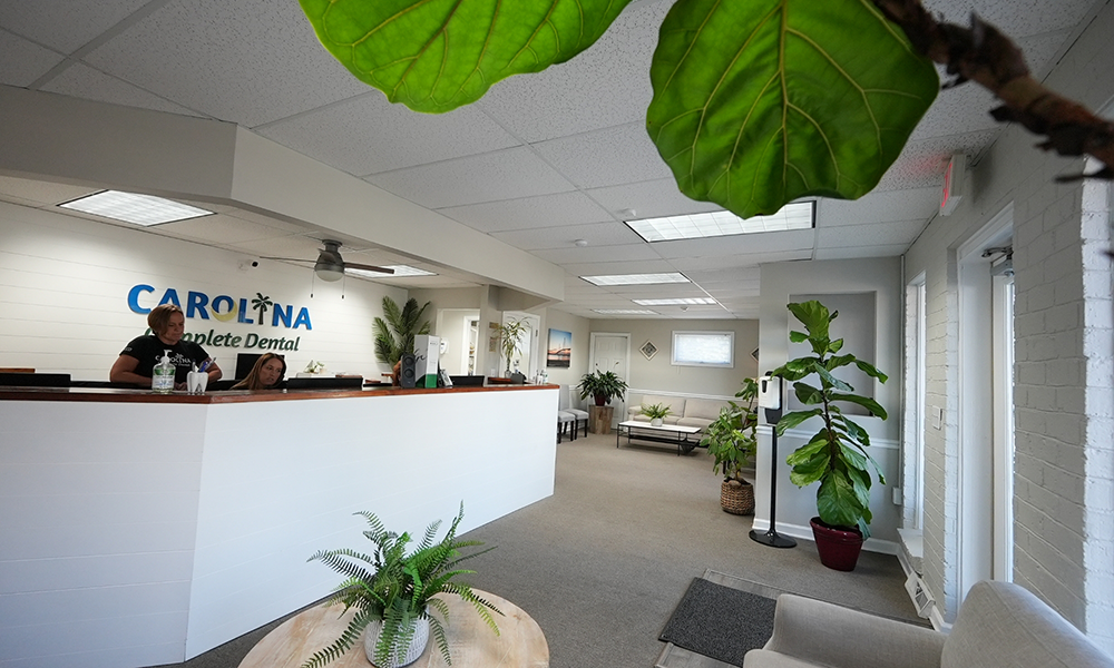 Reception area with Carolina Complete Dental sign on the wall behind the front desk