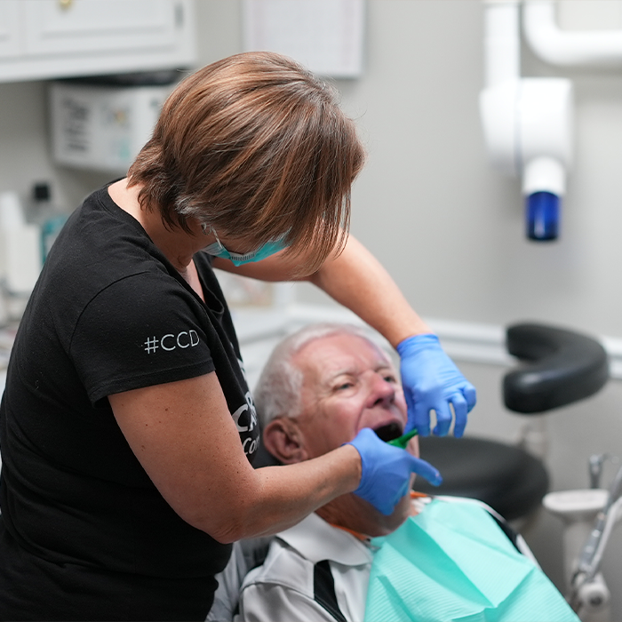 Dentist fitting a patient with a nightguard tray