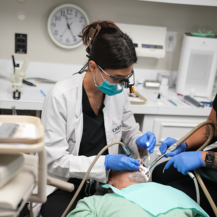 Dentist and dental assistant performing a treatment on a patient