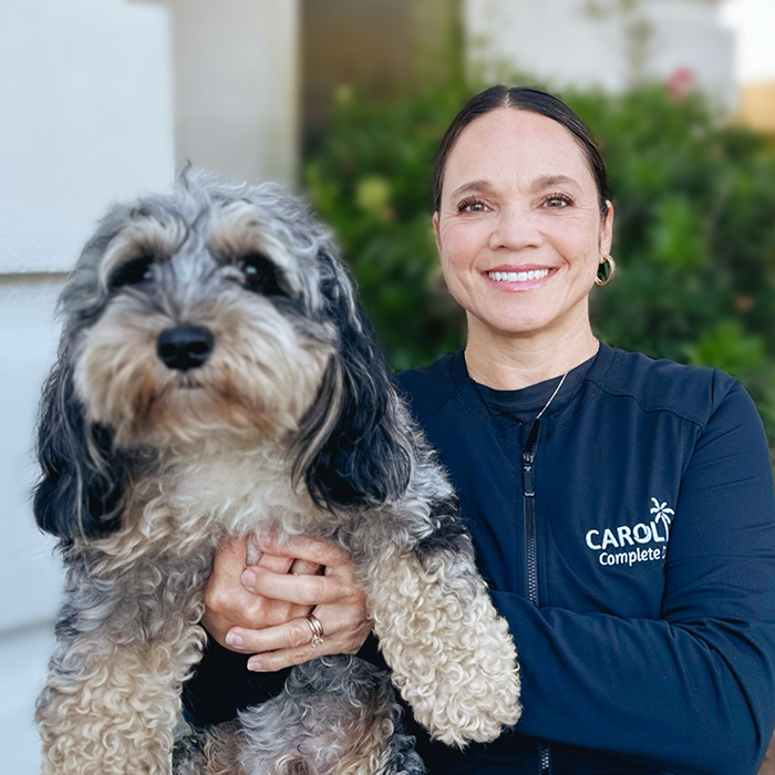 Dental hygienist Kim holding comfort dog Tully